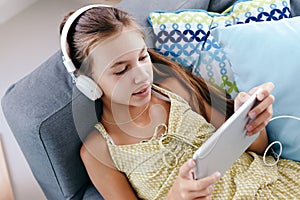 Tween girl relaxing on couch at home