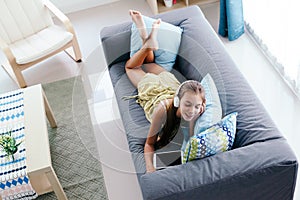 Tween girl relaxing on couch at home