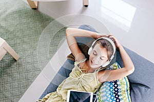 Tween girl relaxing on couch at home