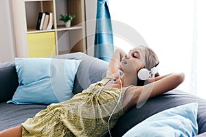 Tween girl relaxing on couch at home