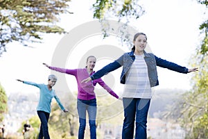 Tween Girls walking along a pond