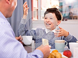 Tweenager enjoying conversation with father