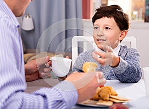 Tweenager enjoying conversation with father