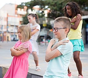 Tweenager performing street dance with group of friends outside