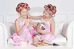 Tweenie girls in hair curlers with dog