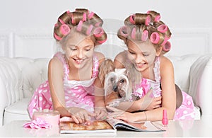 Tweenie girls in hair curlers with dog