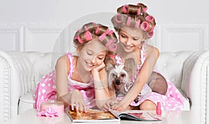 Tweenie girls in hair curlers with dog