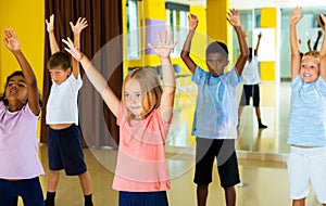 Tweens exercising with choreographer in class