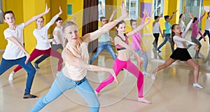 Tweens exercising with coach in choreography class