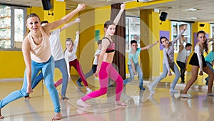 Tweens exercising with coach in choreography class