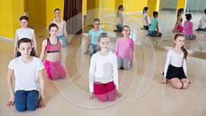 Tweens sitting on floor with female coach