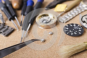 Tweezers, batteries, screwdrivers, dials, wrist watch, verious types of tools for watch repairing