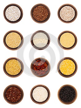 Twelve different cereals in wooden bowls, isolated