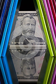 Twelve different colors diaries and US dollar