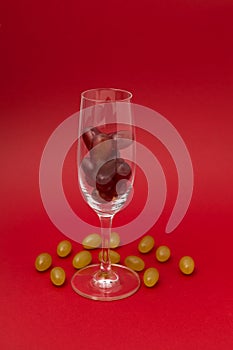 Twelve grapes in glass for sparkling wine cava. Spanish traditional to eat twelve 12 berries for good luck at midnight. Christmas