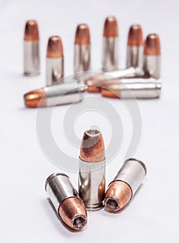 Twelve hollow point 9mm bullets isolated on a white background