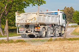 Twelve wheel dump truck, hauling dirt