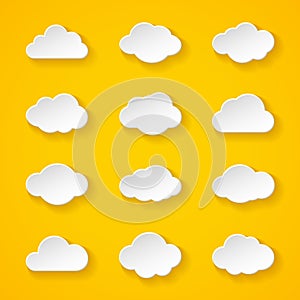 Twelve white paper clouds with different shapes