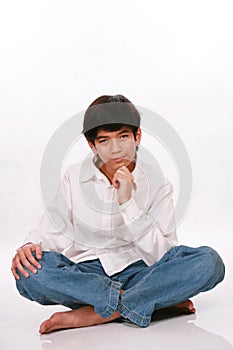 Twelve year old boy sitting, thinking