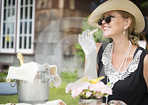 Twenties Dressed Woman Eating and Drinking Champagne At Outdoor