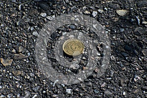 Twenty Cents on Asphalt Ground