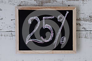 Twenty five percent. Discount and special offer, Price reduction. Blackboard with handwrittent text `25%`