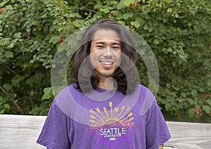 Twenty-five year old Amerasian male posing on wooden bridge in Washington Park Arboretum, Seattle, Washington