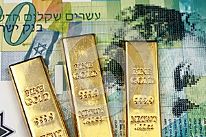 A twenty Israeli shekel bank note with three small gold bars