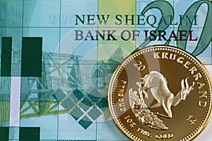 A twenty Israeli shekel note with a golden one ounce krugerrand