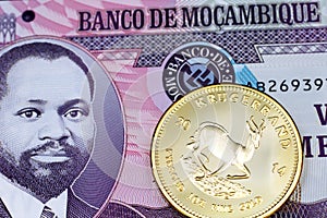 A twenty Mozambique metical note with a gold South African krugerrand