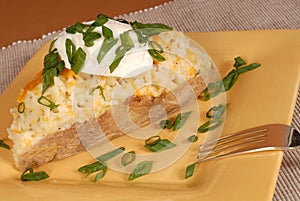 Twice baked potato with scallions, cheese and sour cream photo