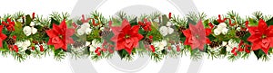Twigs of Christmas tree, poinsettia flower, berries and holiday decorations in seamless garland