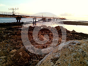 twilight atmosphere when the sea water recedes with a long bridge