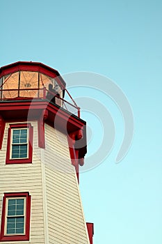 Twilight Bagpiper on Illuminated Lighthouse