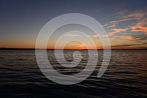 Twilight blue sky over lake water with wave patterns