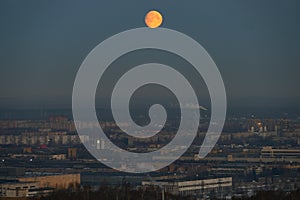 Twilight, moon over the city, panoramic view.