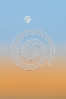 Twilight with orange gradient and light blue sky with moon background