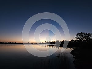 Twilight sun rays over Pine Glades Lake in Everglades National Park, Florida.