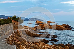 Twilight view of the coastline in le Lavandou, stone trail to the beach St Clair, Var, Cote d`azur Provence, France.