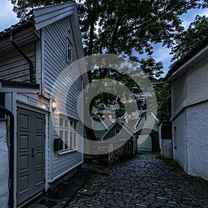 Twilight view of a colorful cobbled street in Bergen old town with typical wooden houses, Norway