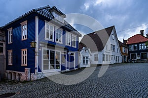 Twilight view of a colorful cobbled street in Bergen old town with typical wooden houses, Norway