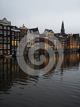 Twilight view of famous dancing houses on Damrak gracht central Amsterdam Holland Netherlands