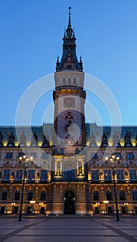 Twilight view of famous Hamburg city hall with Rathausmarkt square illuminated during blue hour