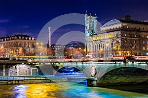 Twilight view onto the Seine at Pont au Change Bridge and Statue