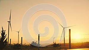 The twilight views of Wind turbines produce electric power. Global warming concept and green energy