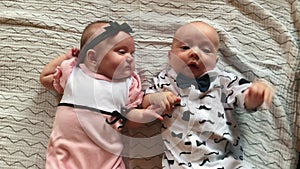 Twin babies. Beautiful a newborn brother and sister kids lie looking at the camera. Happy family kid dream concept. Baby