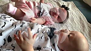 twin babies. beautiful a newborn brother and sister kids lie looking at the camera. happy family kid dream concept. baby