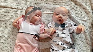 twin babies. beautiful a newborn brother and sister kids lie looking at the camera. happy family kid dream concept. baby