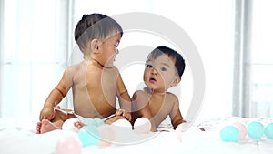 Twin babies crying on bed