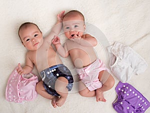 Twin babies girls with ecologic cloth diapers